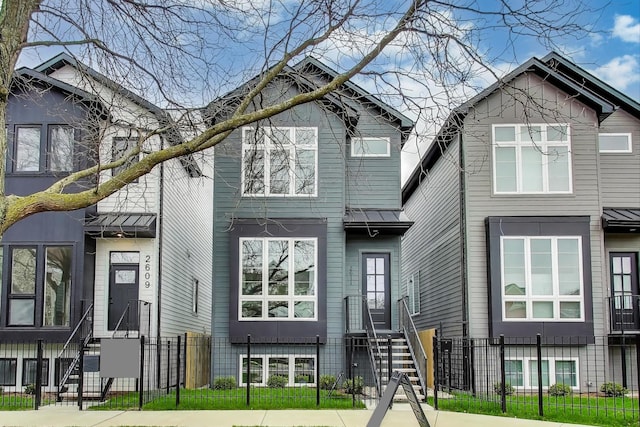 2611 W Carmen Ave, Chicago, IL 60625 - view of front of house featuring a fenced front yard and a standing seam roof