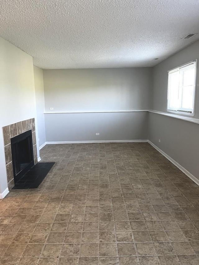 22526 Clarendon Ave, Richton Park, IL 60471 - unfurnished living room featuring a textured ceiling and a tiled fireplace