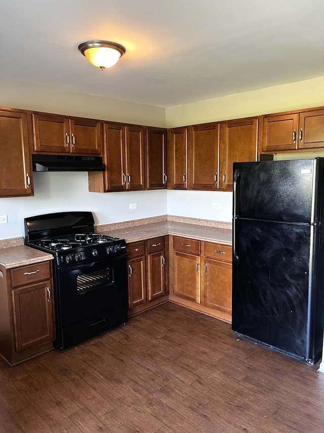 22526 Clarendon Ave, Richton Park, IL 60471 - kitchen with black appliances, under cabinet range hood, and dark wood-style floors