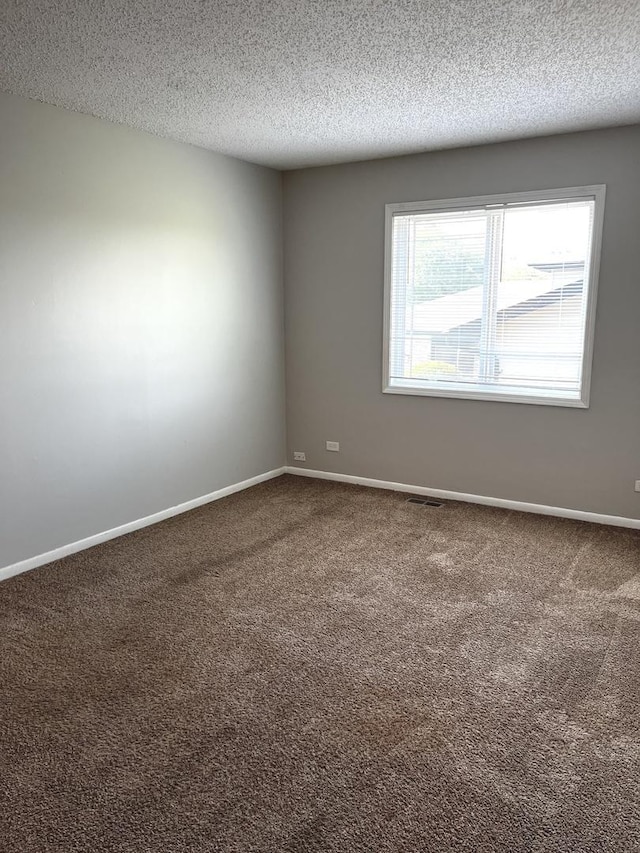 22526 Clarendon Ave, Richton Park, IL 60471 - carpeted spare room featuring a textured ceiling and baseboards