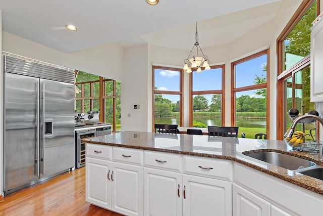 1521 Pendelton Ct, Palatine, IL 60067 - kitchen featuring built in refrigerator, white cabinetry, pendant lighting, recessed lighting, and dark stone countertops