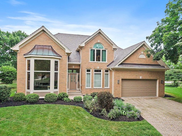 1521 Pendelton Ct, Palatine, IL 60067 - traditional home featuring a front yard, an attached garage, brick siding, and decorative driveway
