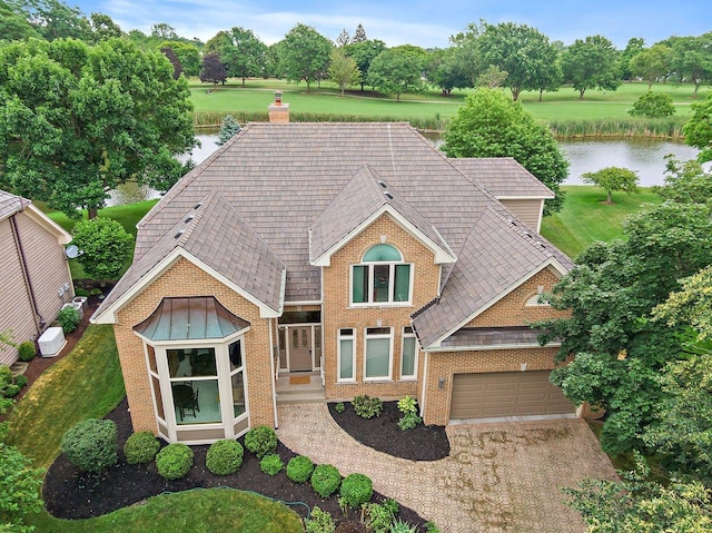 1521 Pendelton Ct, Palatine, IL 60067 - traditional-style home with a water view, a chimney, brick siding, driveway, and an attached garage