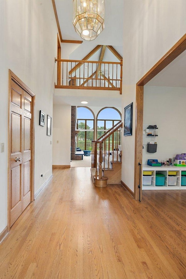 1521 Pendelton Ct, Palatine, IL 60067 - entryway featuring a high ceiling, stairway, wood finished floors, a chandelier, and ornamental molding