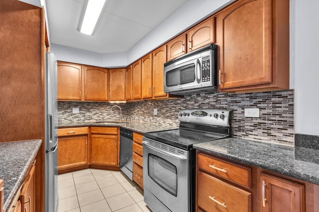 814 N River Rd Unit 1D, Mount Prospect, IL 60056 - kitchen with stainless steel appliances, brown cabinets, light tile patterned floors, and tasteful backsplash