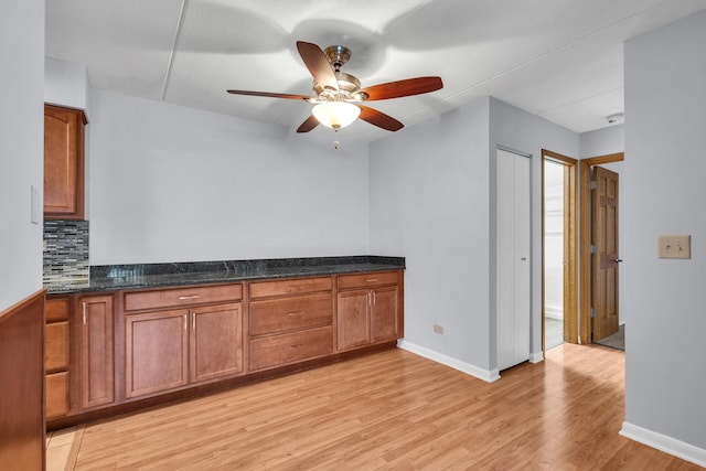 814 N River Rd Unit 1D, Mount Prospect, IL 60056 - kitchen with light wood finished floors, brown cabinetry, a ceiling fan, and backsplash