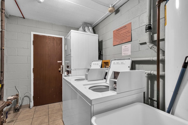 814 N River Rd Unit 1D, Mount Prospect, IL 60056 - communal laundry room with concrete block wall, tile patterned flooring, and washer and clothes dryer