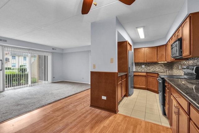 814 N River Rd Unit 1D, Mount Prospect, IL 60056 - kitchen with appliances with stainless steel finishes, brown cabinetry, open floor plan, ceiling fan, and backsplash