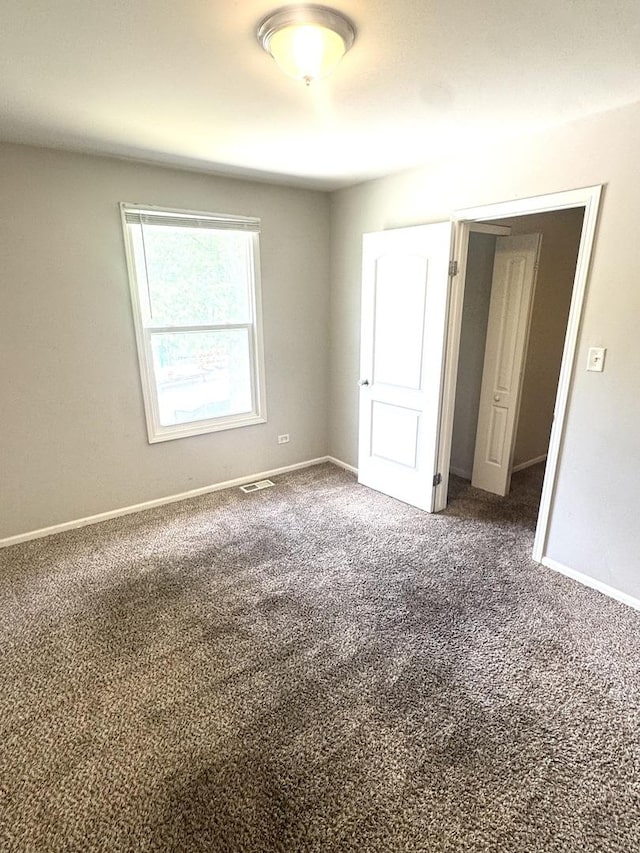 706 Carnation Ln, Matteson, IL 60443 - unfurnished bedroom featuring carpet flooring and baseboards