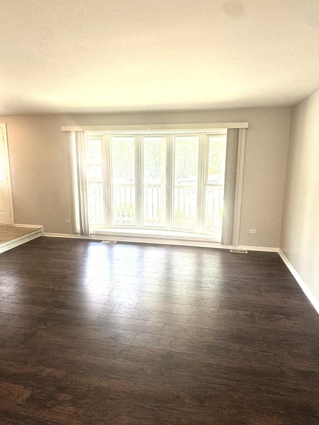 706 Carnation Ln, Matteson, IL 60443 - empty room with baseboards and dark wood-type flooring