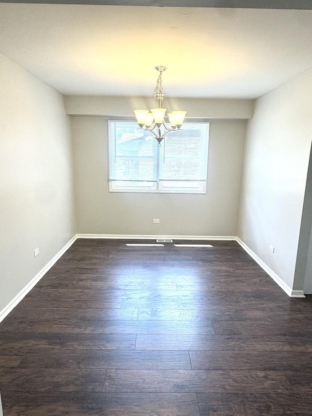 706 Carnation Ln, Matteson, IL 60443 - unfurnished room with a chandelier and dark wood-style flooring