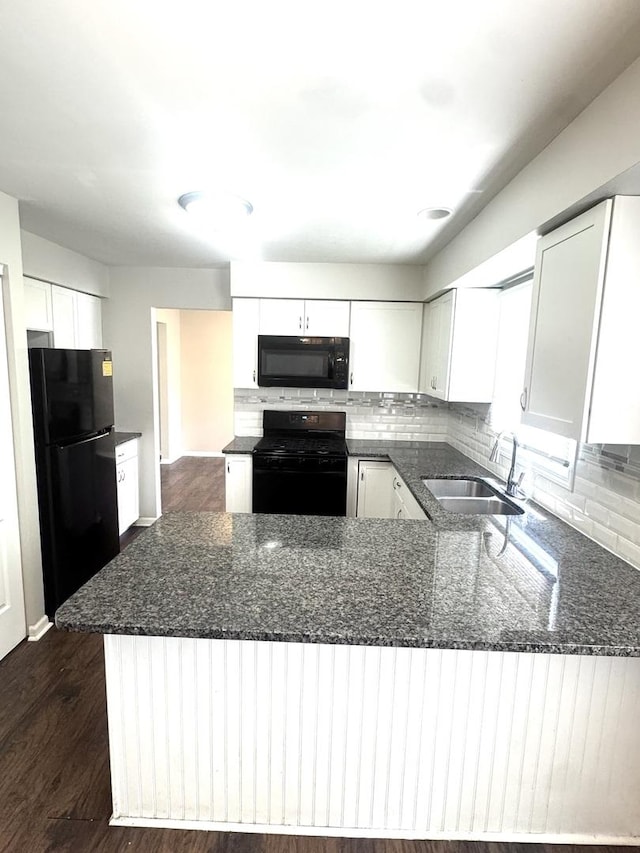 706 Carnation Ln, Matteson, IL 60443 - kitchen with black appliances, dark stone counters, backsplash, white cabinets, and a peninsula