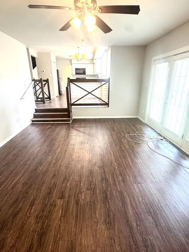 706 Carnation Ln, Matteson, IL 60443 - unfurnished living room with dark wood-style floors, ceiling fan, and stairs