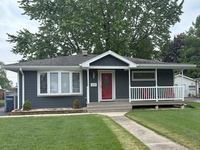 417 Major Dr, Northlake, IL 60164 - view of front of home featuring a front yard, covered porch, a chimney, and a shingled roof