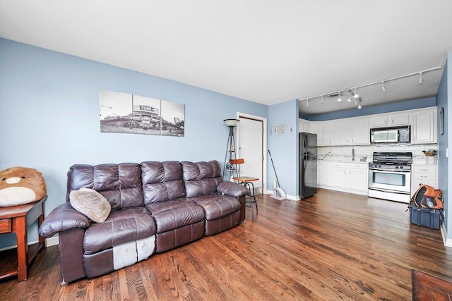 3848 25th Ave Unit 5, Schiller Park, IL 60176 - living area with dark wood-style floors and rail lighting
