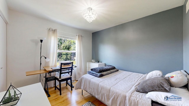 554 Foxford Rd, Bartlett, IL 60103 - bedroom featuring light wood-style flooring and a chandelier
