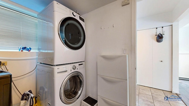 554 Foxford Rd, Bartlett, IL 60103 - laundry area with stacked washer / dryer and light tile patterned flooring