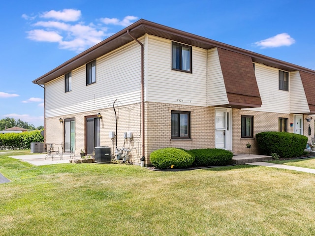 8429 162nd Pl Unit 3, Tinley Park, IL 60487 - rear view of house featuring a lawn, brick siding, and a patio