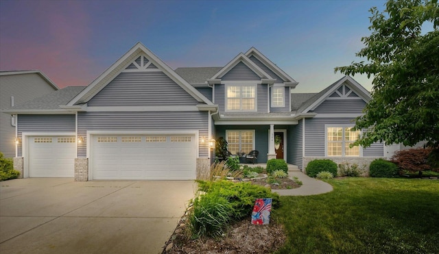 204 Campbell St, Tolono, IL 61880 - craftsman house with driveway, a garage, covered porch, a front lawn, and a shingled roof