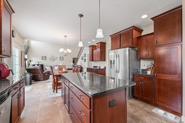 204 Campbell St, Tolono, IL 61880 - kitchen with stainless steel appliances, a chandelier, open floor plan, a kitchen island, and dark stone countertops