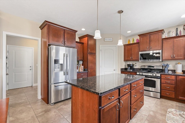 204 Campbell St, Tolono, IL 61880 - kitchen with stainless steel appliances, a center island, light tile patterned floors, dark stone counters, and recessed lighting