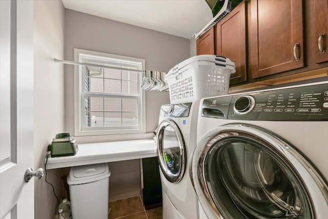 204 Campbell St, Tolono, IL 61880 - washroom featuring washing machine and clothes dryer, cabinet space, and tile patterned floors