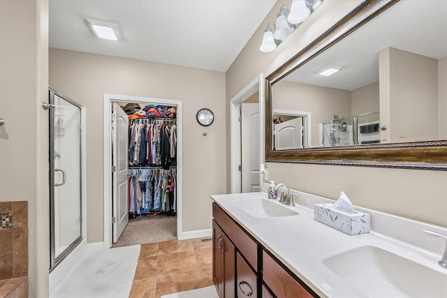 204 Campbell St, Tolono, IL 61880 - bathroom with a stall shower, double vanity, and a walk in closet
