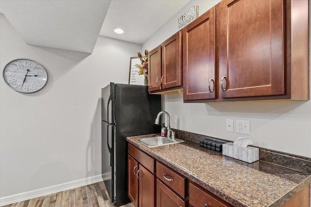 204 Campbell St, Tolono, IL 61880 - kitchen featuring dark countertops, light wood-style flooring, recessed lighting, and freestanding refrigerator