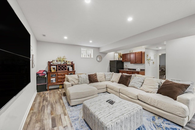 204 Campbell St, Tolono, IL 61880 - living area featuring light wood-style floors, recessed lighting, and bar area