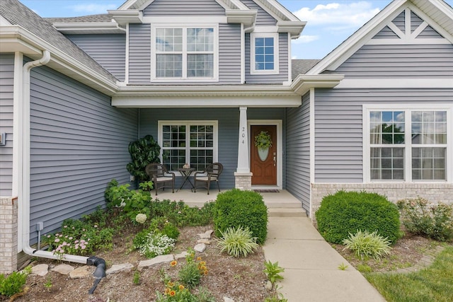 204 Campbell St, Tolono, IL 61880 - view of exterior entry featuring covered porch and a shingled roof