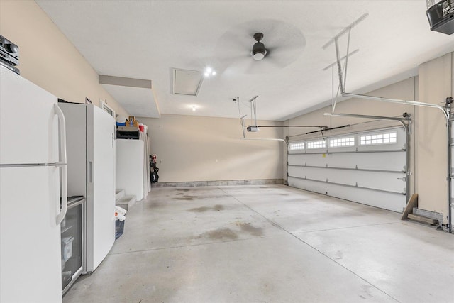 204 Campbell St, Tolono, IL 61880 - garage with a garage door opener and freestanding refrigerator