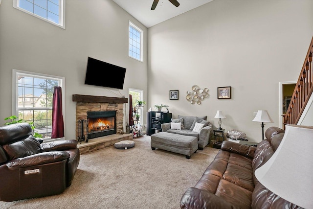 204 Campbell St, Tolono, IL 61880 - living area with a high ceiling, carpet, stairs, a fireplace, and ceiling fan