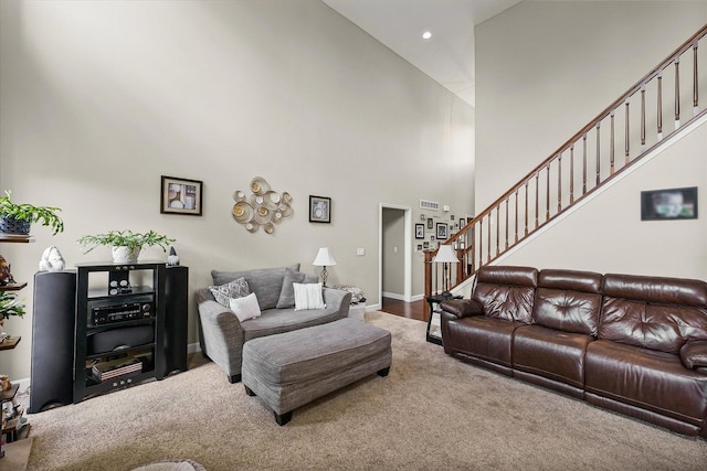 204 Campbell St, Tolono, IL 61880 - carpeted living area with a towering ceiling, stairway, and recessed lighting