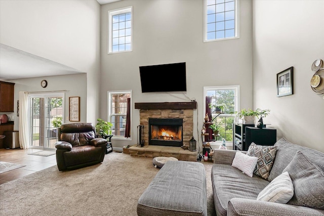 204 Campbell St, Tolono, IL 61880 - tiled living area with a towering ceiling, a fireplace, and healthy amount of natural light