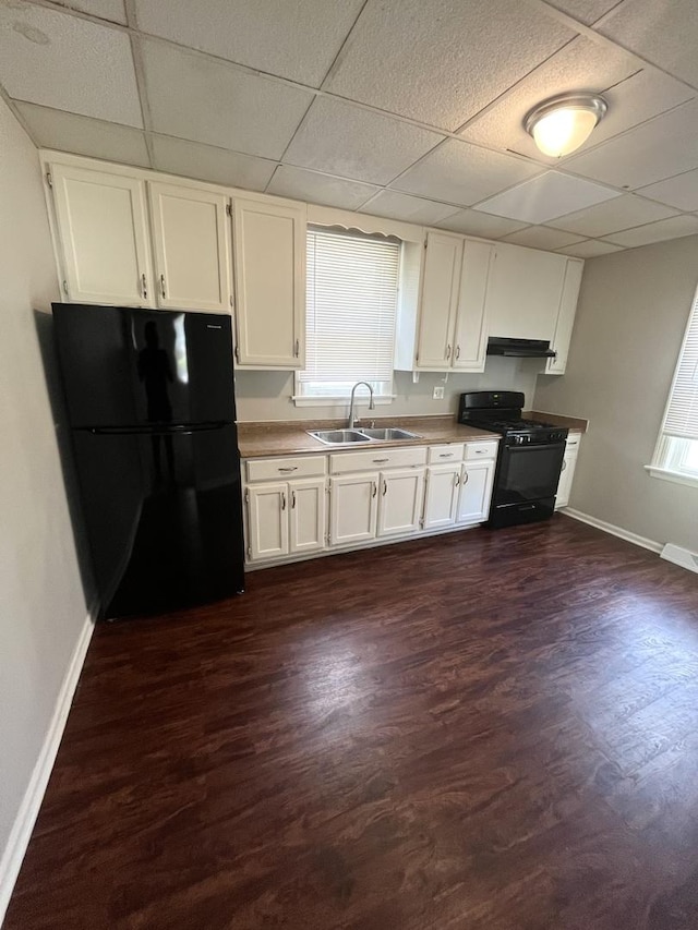 21142 Locust St, Matteson, IL 60443 - kitchen with black appliances, a paneled ceiling, white cabinets, under cabinet range hood, and dark wood-type flooring