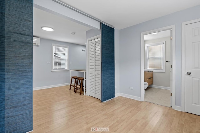 5128 W Carmen Ave, Chicago, IL 60630 - unfurnished room featuring light wood-style floors, plenty of natural light, and a wall mounted air conditioner