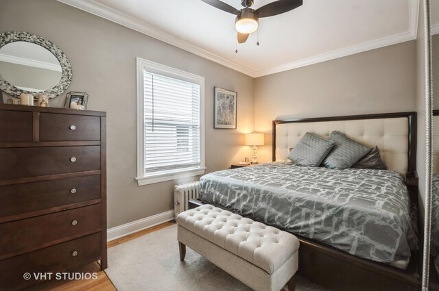 5128 W Carmen Ave, Chicago, IL 60630 - bedroom with crown molding, light wood-style flooring, multiple windows, and radiator