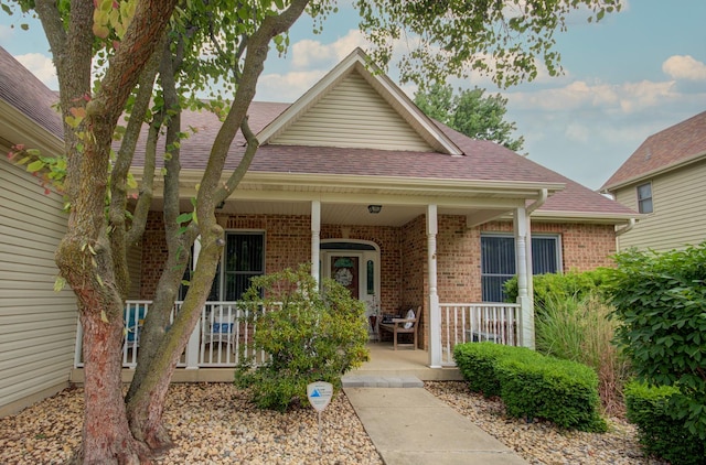 332 Stonemill Ln, Oswego, IL 60543 - view of front of property with covered porch, brick siding, and roof with shingles