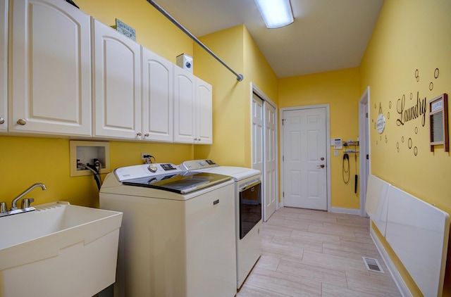 332 Stonemill Ln, Oswego, IL 60543 - washroom featuring washing machine and clothes dryer, cabinet space, and light wood-style flooring