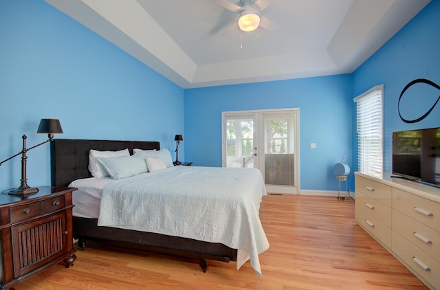 332 Stonemill Ln, Oswego, IL 60543 - bedroom with a tray ceiling, light wood-type flooring, access to exterior, french doors, and a ceiling fan