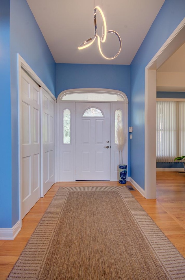 332 Stonemill Ln, Oswego, IL 60543 - foyer entrance featuring a chandelier and wood finished floors