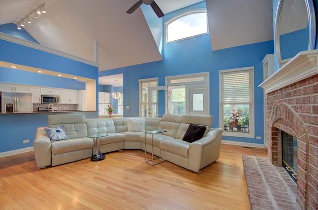 332 Stonemill Ln, Oswego, IL 60543 - living room with track lighting, high vaulted ceiling, a ceiling fan, plenty of natural light, and light wood finished floors