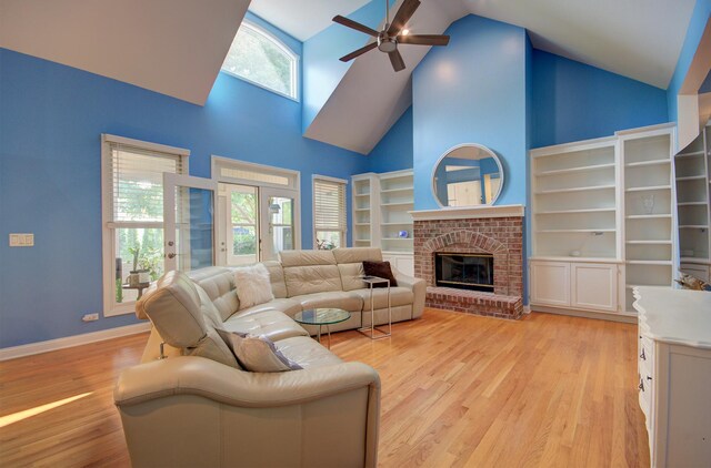 332 Stonemill Ln, Oswego, IL 60543 - living room featuring a ceiling fan, high vaulted ceiling, light wood finished floors, and a brick fireplace