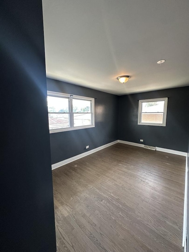 360 Chappel Ave, Calumet City, IL 60409 - empty room featuring healthy amount of natural light and dark wood-style floors