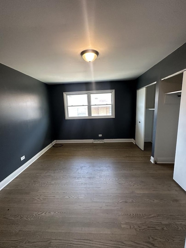 360 Chappel Ave, Calumet City, IL 60409 - unfurnished bedroom featuring dark wood-style flooring and two closets