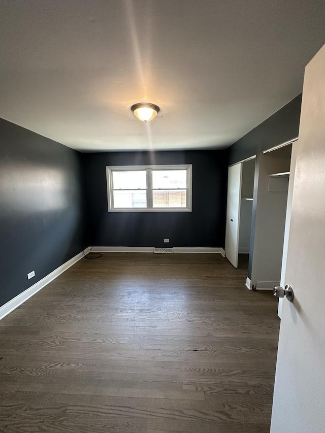 360 Chappel Ave, Calumet City, IL 60409 - unfurnished bedroom with dark wood-style floors and multiple closets