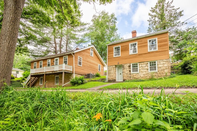 244 S Division St, Galena, IL 61036 - colonial home featuring stairway, a chimney, a wooden deck, and stone siding