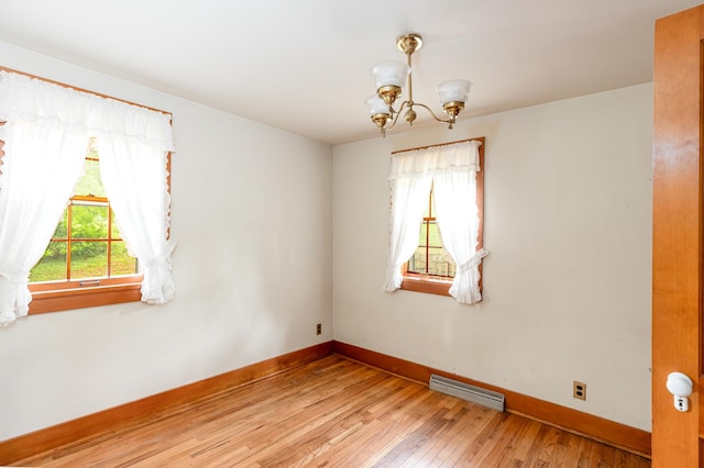 244 S Division St, Galena, IL 61036 - spare room with a chandelier and hardwood / wood-style flooring