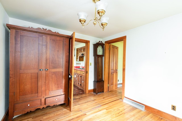 244 S Division St, Galena, IL 61036 - unfurnished bedroom with light wood-type flooring, a chandelier, and a closet