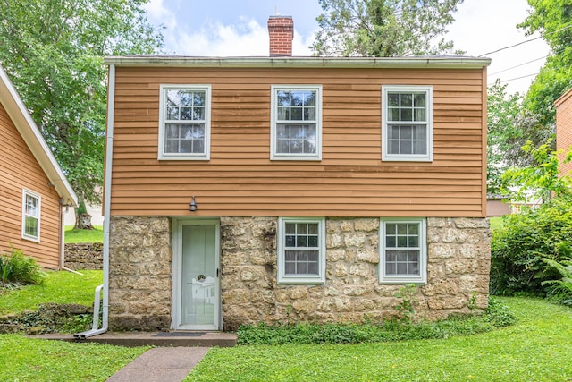 244 S Division St, Galena, IL 61036 - colonial house with a chimney, a front lawn, and stone siding